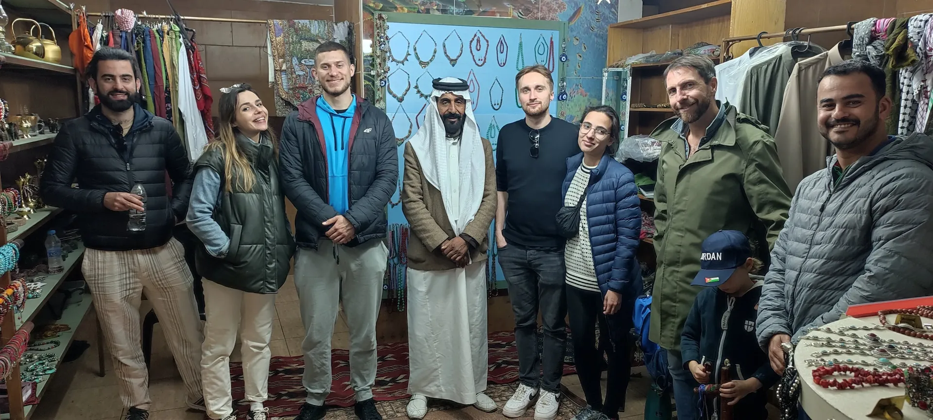 A group of people enjoying street food in a local market in Aqaba