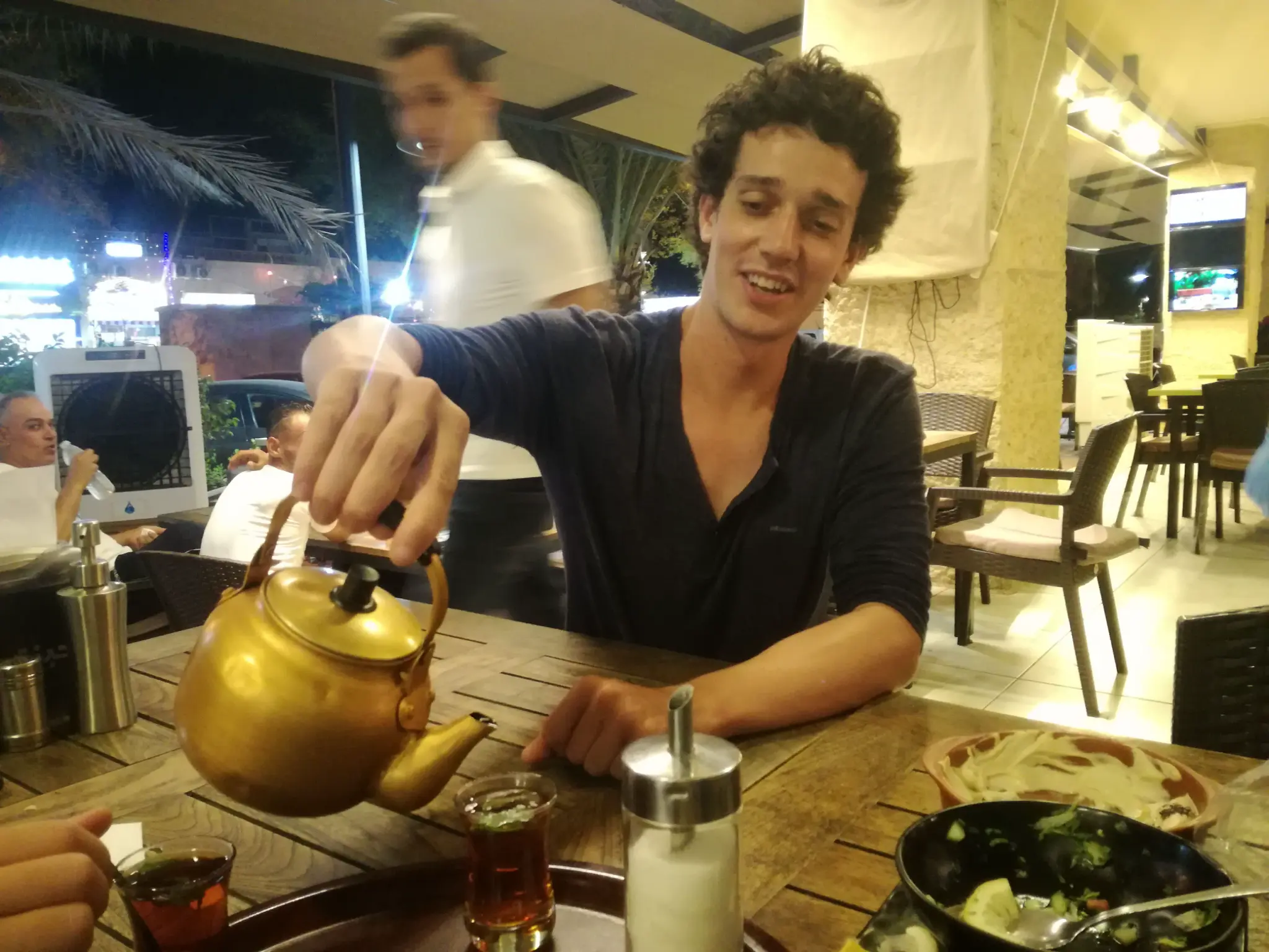 A traveler enjoying traditional mint tea at a local cafe in Aqaba
