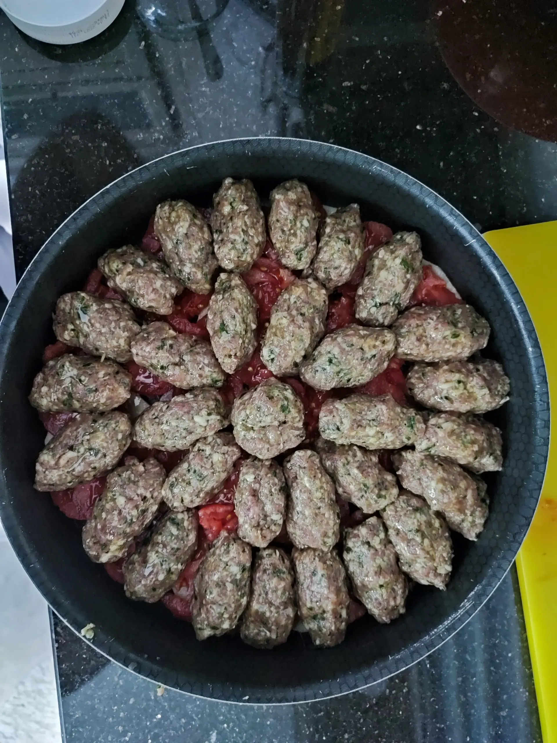 An instructor demonstrating how to make Maqluba.